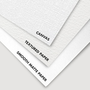 Close-up of three different types of paper and canvas: smooth matte paper, textured paper, and canvas. The words "Smooth Matte Paper", "Textured Paper", and "Canvas" are printed on each surface.