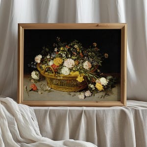 Framed painting of vibrant flowers in a basket on a draped table, set against a soft white curtain. The scene evokes a serene, classic elegance.