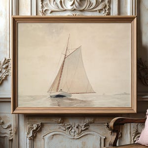 Framed nautical painting of a lone sailboat on calm waters, hanging on an ornate, textured wall. The setting feels serene and vintage.