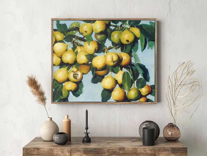 A framed painting of ripe yellow pears on leafy branches hangs on a textured white wall. Below, a wooden shelf holds vases and candles, creating a serene, artistic atmosphere.