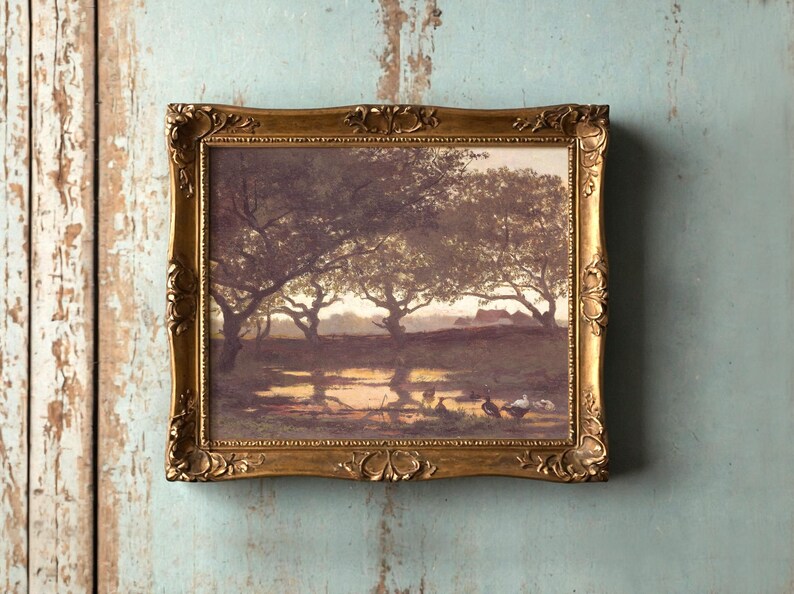A framed painting on a vintage wall shows a serene landscape with trees and birds by a pond at sunset, conveying a peaceful and nostalgic mood.