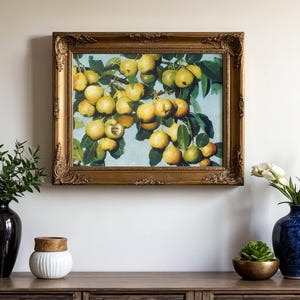 Framed painting of yellow pears hangs on a wall above a wooden console. Vases with green plants and white tulips add elegance and color.