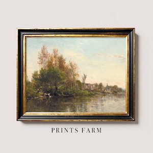 An antique landscape painting depicting a serene river scene with trees, a small boat, and buildings in the distance. The artwork is framed in a black and gold ornate frame, adding to its vintage appeal.