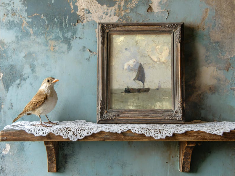 A sparrow perches on a lace-covered shelf next to a framed painting of a sailing ship under cloudy skies. The backdrop is a textured, weathered blue wall.