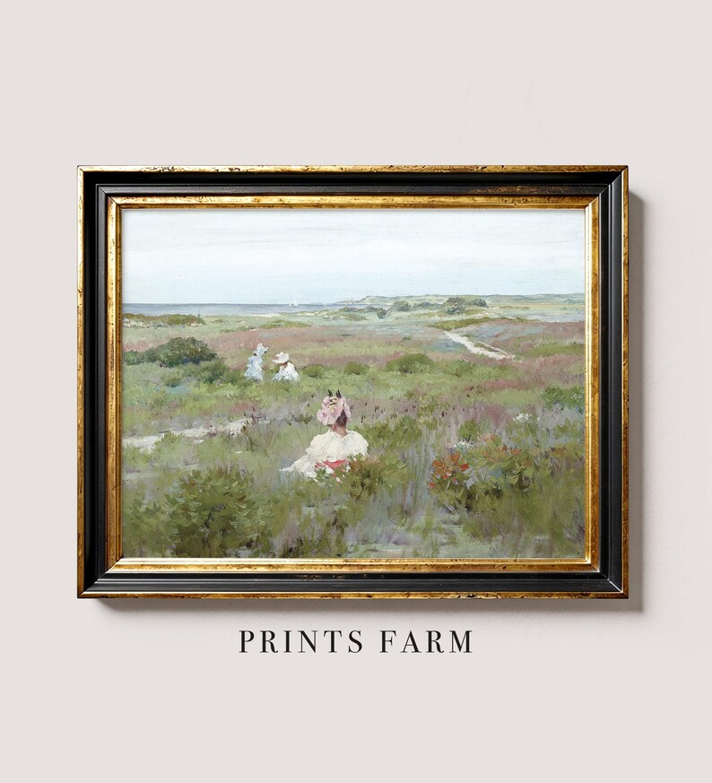 Framed painting of a serene landscape with three people in white clothing seated in a colorful field. Soft tones evoke a peaceful, idyllic scene.