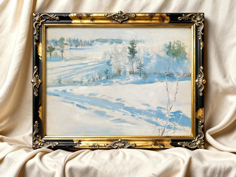 Framed painting of a serene winter landscape, showcasing snow-covered fields and distant trees. The ornate black and gold frame adds elegance.