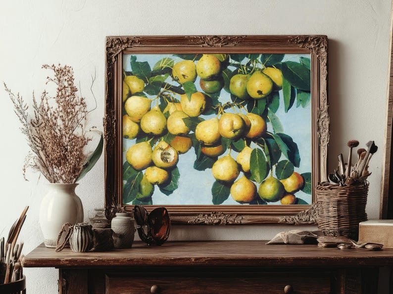 Framed painting of pears on a wooden table. Vase with dried flowers and art brushes in a basket. Warm, rustic setting with a creative ambiance.