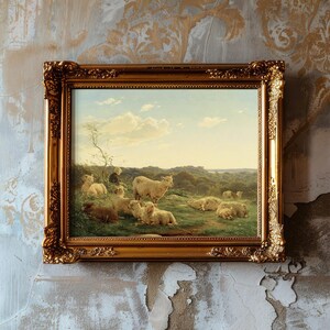 A framed painting depicting sheep grazing on a lush meadow under a blue sky with fluffy clouds, set against a textured, vintage wall.