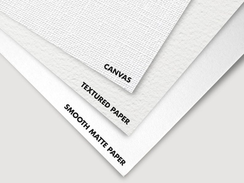 Close-up of three different surfaces: smooth matte paper, textured paper, and canvas. The surfaces are labeled with their names.