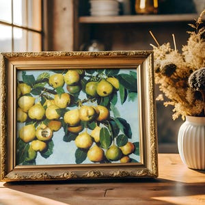 A framed painting of ripe pears on a branch, sits on a wooden table beside a vase of dried flowers. Sunlight streams through a window, creating a warm, cozy ambiance.