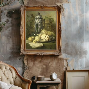 A rustic room features a vintage armchair, a potted plant, and a tall lamp. A classical still-life painting with fruits and a jug hangs on the textured wall.