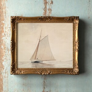 A painting of a sailboat on calm waters in a vintage gold frame hangs on a distressed, light-blue wall, evoking a serene and nostalgic mood.