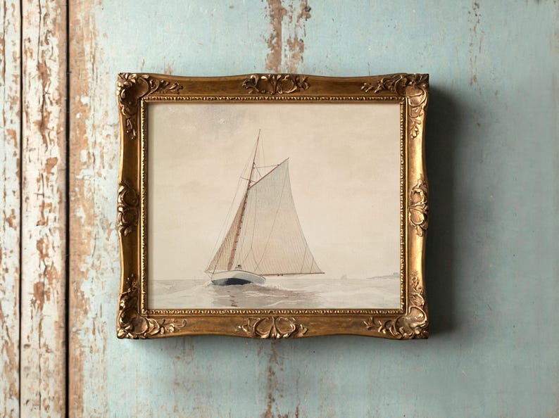 A painting of a sailboat on calm waters in a vintage gold frame hangs on a distressed, light-blue wall, evoking a serene and nostalgic mood.