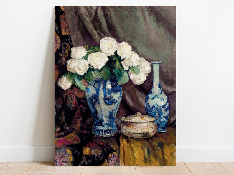 Painting of a still life with white roses in a blue vase, a matching blue pitcher, and a small bowl on a draped table, exuding a serene elegance.
