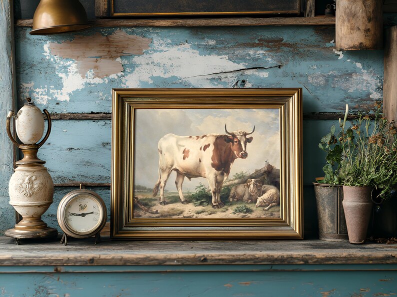 A rustic shelf displays a vintage cow painting in a gold frame, flanked by a decorative lamp, antique clock, and potted plants against a distressed blue wall.