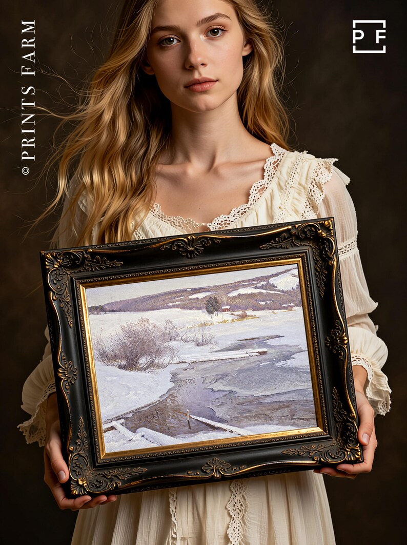 A woman in a vintage white dress holds a framed winter landscape painting depicting a snowy field and icy river, exuding a serene and contemplative mood.