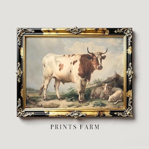 Framed artwork of a brown and white cow with sheep lying beside it, set in a rural landscape with a cloudy sky. Ornate black and gold frame.