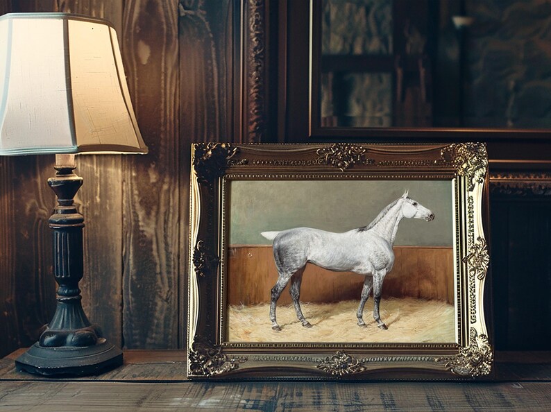 Framed painting of a white horse stands on a wooden shelf beside an ornate lamp. The scene exudes a warm, vintage ambiance with rich tones.