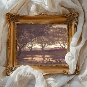 Ornate gold-framed painting of a serene landscape with trees, soft light, and shadows. Surrounded by draped, textured white fabric. Tranquil and artistic ambiance.