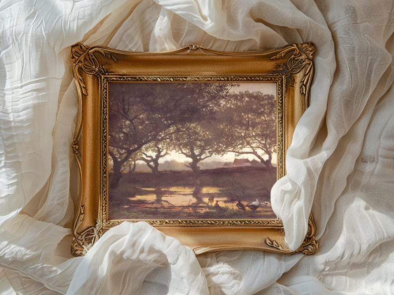 Ornate gold-framed painting of a serene landscape with trees, soft light, and shadows. Surrounded by draped, textured white fabric. Tranquil and artistic ambiance.