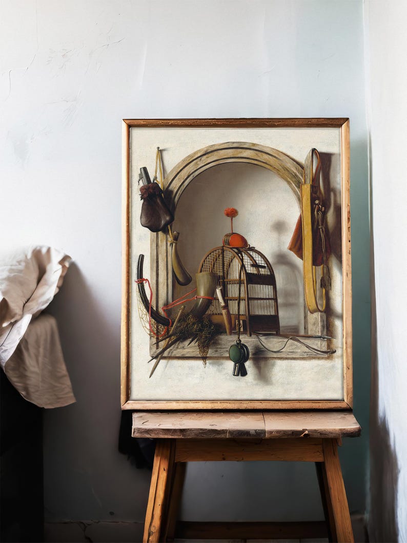 A framed painting on an easel shows a surreal still life with a birdcage, arched window, and hanging objects. The scene is set in a softly lit room.