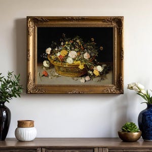 A framed painting of a lush flower basket on a wall with a dark background. Below are decorative vases with flowers and plants, creating an elegant scene.