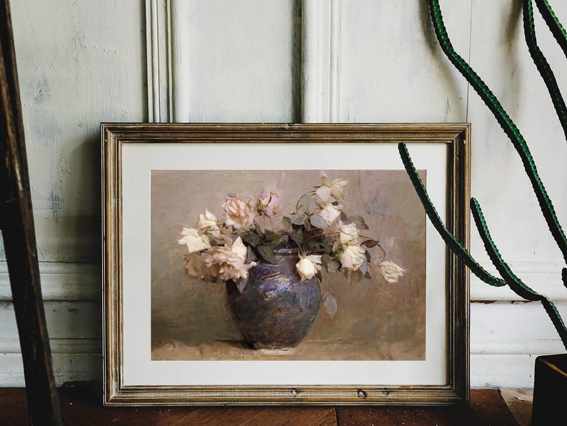 A painting of a bouquet of white and pink roses in a dark blue ceramic vase. The roses are arranged in a loose, natural style, and the vase is set on a table with a light brown surface.