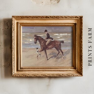 A framed painting depicts a person on horseback with a dog on a beach. The scene is serene, with soft colors and an antique-style frame. "PRINTS FARM" is visible on the wall.