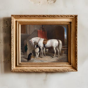 Framed painting on a textured wall depicting a white horse with a saddle, two dogs sitting nearby. Warm tones evoke a serene, nostalgic scene.