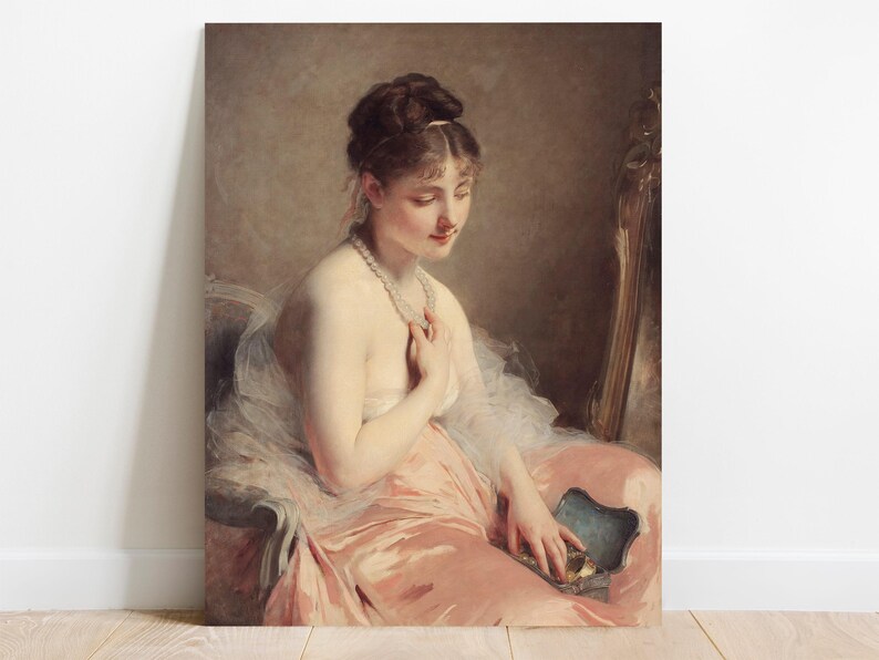 A graceful woman in a flowing pink dress gazes down contemplatively, holding a necklace. The setting is elegant, with warm tones and soft lighting.