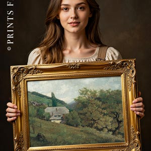 A young woman with long hair, wearing a beige dress, holds a framed landscape painting. The background is dark, highlighting her serene expression.