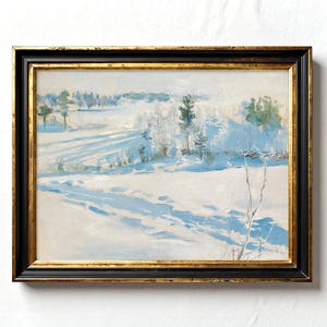 A framed painting depicts a serene winter landscape with snow-covered fields and distant trees under a soft blue sky, conveying tranquility.