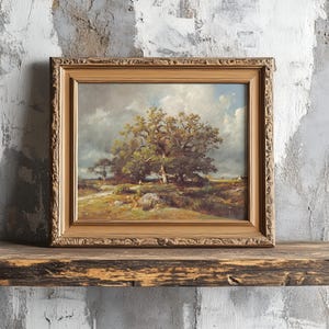 A framed landscape painting of a large tree under a cloudy sky rests on a rustic wooden shelf against a textured, weathered wall. The scene evokes tranquility.