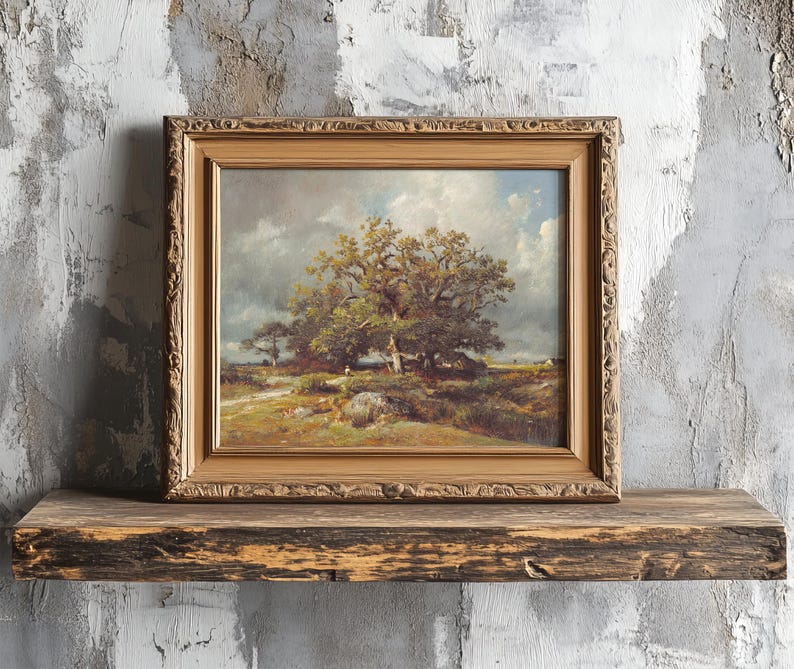A framed landscape painting of a large tree under a cloudy sky rests on a rustic wooden shelf against a textured, weathered wall. The scene evokes tranquility.