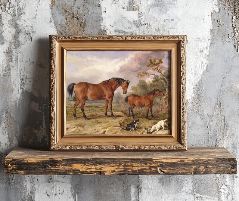 A framed painting of two horses and two dogs in a pastoral setting rests on a rustic wooden shelf against a textured, distressed wall.