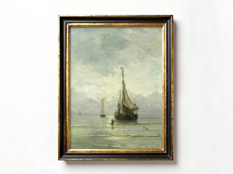 A framed oil painting depicting a seascape with two sailboats on a calm, blue-grey sea. The sky is a light blue with white clouds. The painting is in a dark wood frame with a gold trim.