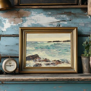 A coastal painting in a gold frame rests on a rustic shelf. Beside it, an antique lamp and clock sit on worn, peeling blue wood, while potted plants add greenery.