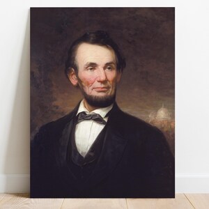 Portrait of a bearded man in a suit with a bow tie, set against a dark background. A faint structure, possibly a building, is visible in the distance.