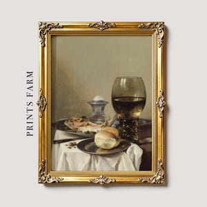 A classic still life painting with a gold frame shows a table with bread, a filled wine glass, and a plate of food, conveying an elegant, serene tone.