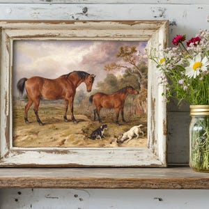A framed painting of two brown horses with three dogs in a pastoral scene stands on a rustic shelf. Next to it is a mason jar filled with colorful wildflowers.