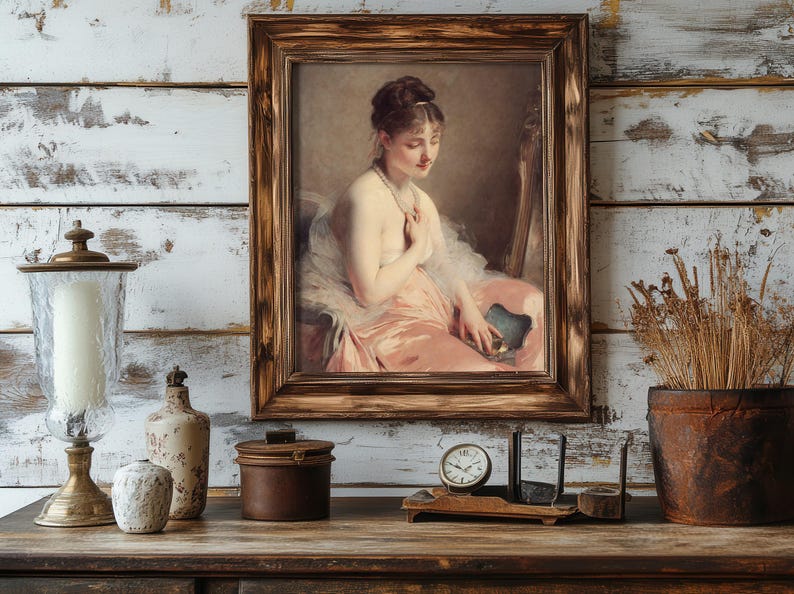 A vintage painting of a seated woman in a pink dress, framed in wood, hangs on a rustic white wall. Nearby are a candle, jars, clock, and dried plants. Cozy and nostalgic mood.