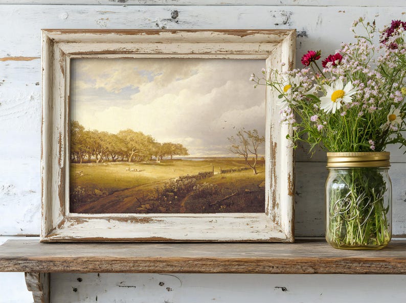 A rustic scene with a weathered wooden shelf holds a vintage landscape painting in a distressed frame. Beside it, a mason jar with vibrant wildflowers.