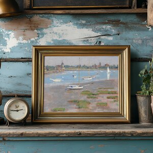 A framed landscape painting of sailboats on a serene blue lake is placed on a rustic shelf. Surrounding it are a vintage clock, a decorative lamp, and potted plants, set against a distressed blue wooden wall.