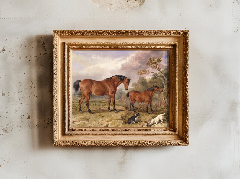 A framed painting features two horses standing on grassy land with two dogs lying nearby. The sky is cloudy, and a tree is in the background.