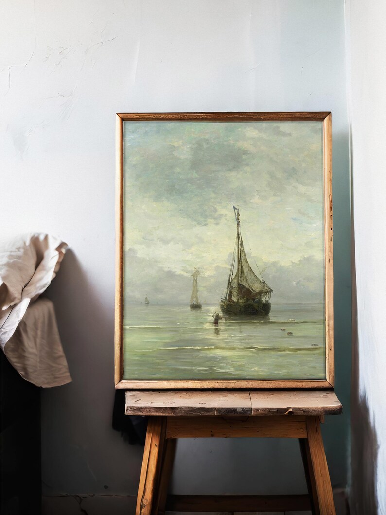 Framed painting on an easel depicting a serene seascape with sailing ships under a cloudy sky. Soft colors and textured brushstrokes create a calm, nostalgic mood.