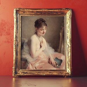 A classic painting in an ornate gold frame depicts a seated woman in a pink dress holding a fan. She's gazing down thoughtfully.
