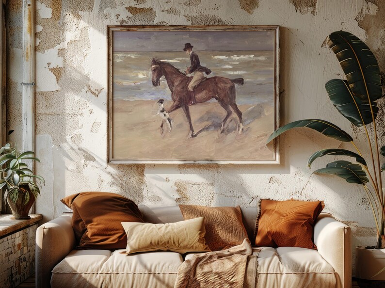 A cozy living room features a textured wall with a beach painting of a rider on horseback. A white sofa with brown pillows adds warmth and relaxation.