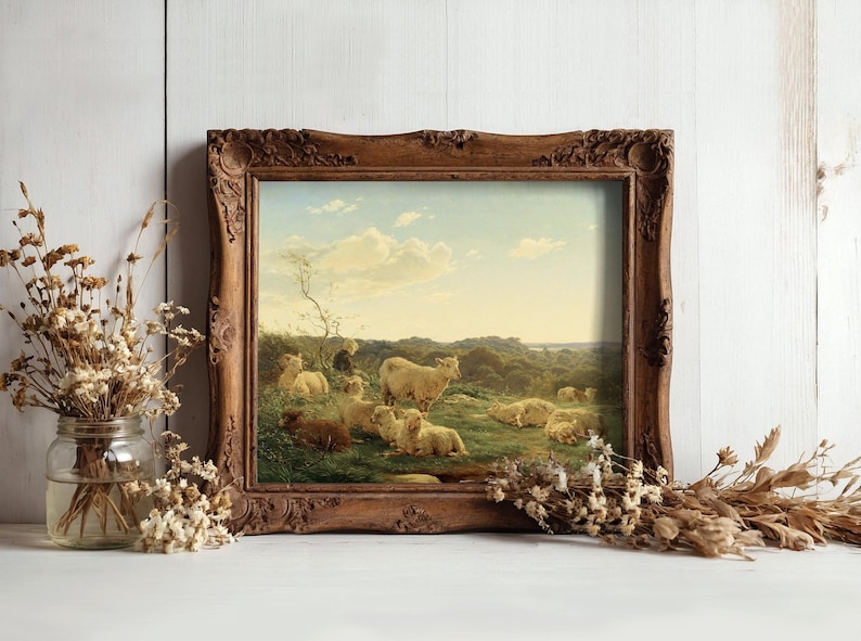 A rustic wooden frame displays a pastoral painting of sheep grazing in a sunlit field. Dried flowers in glass jars surround the artwork, adding a rustic charm.