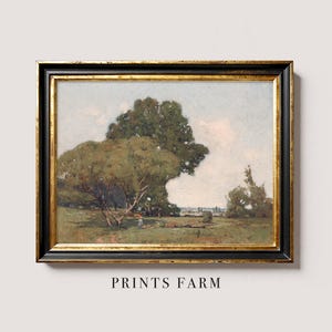 A landscape painting titled "Prints Farm," featuring a scenic rural view with large, leafy trees, a small figure walking on the grass, and a distant horizon under a partly cloudy sky. The painting is framed in an ornate black and gold frame and is displayed against a light-colored wall.