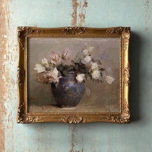 A vintage painting of pale roses in a blue vase, framed in ornate gold, hangs on a distressed teal wall, evoking a calm, nostalgic mood.